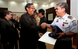 staf ahli gubernur Drs. Sumawijaya, M.Si, saat menyerahkan anugrah ke Kota tangsel yang diwakili H. Sukanta Kadihubkominfo Tangsel